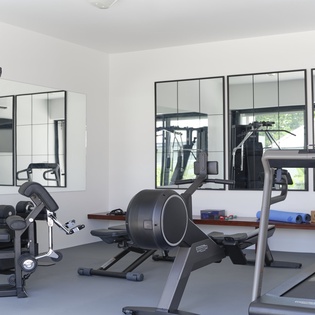 This fully-equipped fitness center features cardio machines, strength training equipment, free weights, and floor space for stretches and yoga—helping you maintain your routine while away.