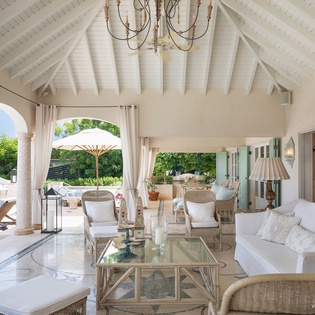 Sink into plush cushions beneath vaulted ceilings as gentle breezes drift through flowing curtains. Your private terrace opens to lush gardens where sunny afternoons unfold at your own pace.