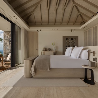 Wake up to pristine white linens and tropical breezes flowing through your oceanfront sanctuary, where modern elegance meets paradise.