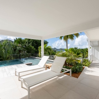 Unwind on your private covered terrace with pool loungers and tropical views surrounding your infinity pool.
