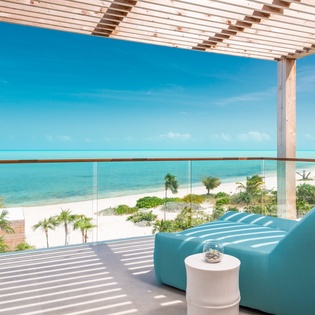 Unwind in your private oceanfront sanctuary where turquoise waters meet pristine sand just steps away from your covered terrace.