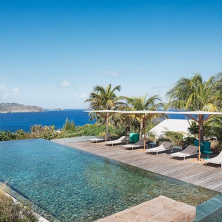 Stunning infinity pool with ocean views and tropical paradise surroundings creates the perfect Caribbean escape.