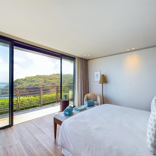 Your bedroom opens to breathtaking ocean views and private balcony, where crisp linens and modern design create the perfect coastal retreat.