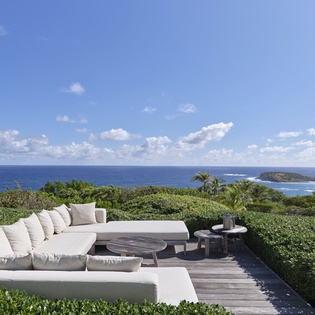 Breathtaking coastal panorama stretches before your private terrace oasis, where island views meet endless ocean horizons under open skies.