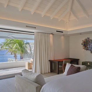Wake up to stunning sea views and gentle ocean breezes in your serene waterfront bedroom.