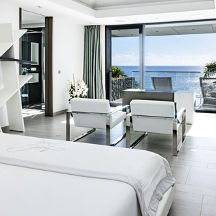 Wake up to breathtaking ocean views from your elegantly appointed suite, where modern luxury meets seaside serenity in perfect harmony.