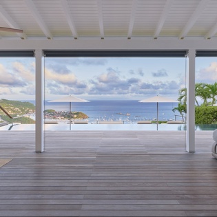 Gaze out at the stunning infinity pool merging with the endless blue sea horizon. Your private terrace offers a serene escape where Caribbean views and tropical breezes create pure tranquility.