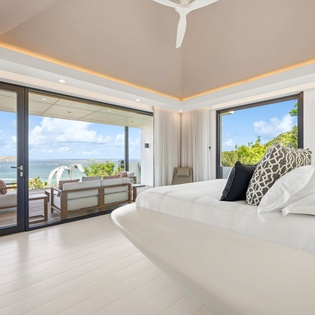 Wake up to breathtaking ocean views from your luxurious bedroom, where floor-to-ceiling windows frame paradise and your private terrace awaits.
