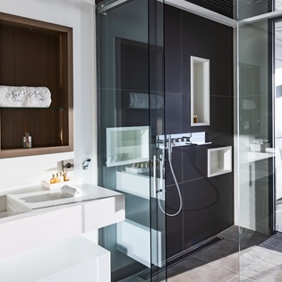 Step into your luxury bathroom featuring a sleek glass-enclosed shower, modern double vanity, and stunning contemporary design details.
