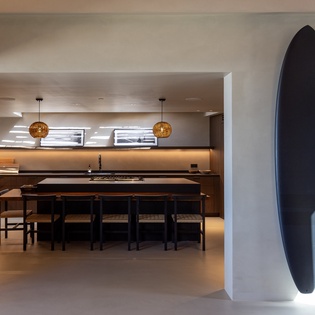 Gather around your sleek kitchen island where warm pendant lighting creates the perfect atmosphere for cooking and conversation.