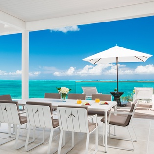 Dine al fresco at your private oceanfront terrace, where turquoise waters stretch endlessly before you.