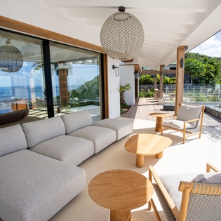 Unwind in your stunning living space with breathtaking ocean views through floor-to-ceiling windows.