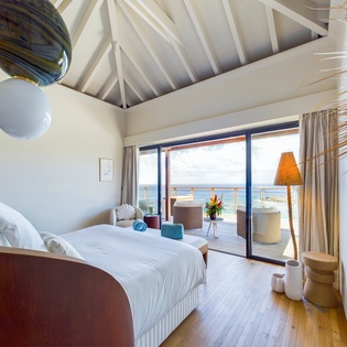 Wake up to panoramic ocean views from your dreamy suite, where artistic touches and tropical elegance create your perfect retreat.