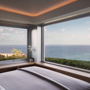 Wake up to breathtaking ocean views from your bed, where floor-to-ceiling windows frame endless blue horizons in this serene seaside sanctuary.