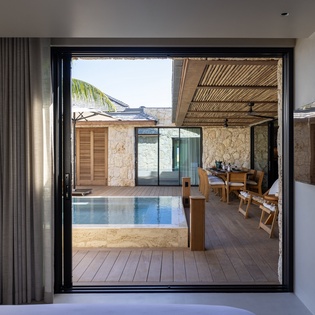 Step from your room onto the private terrace where your personal pool awaits, perfectly framed by natural stone and tropical views.