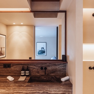 Unwind in your elegantly appointed bathroom featuring rich wood vanity, premium amenities, and sophisticated modern design.