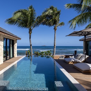 Wake up to your own slice of paradise with an infinity pool overlooking turquoise waters and swaying palms at your beachfront retreat.