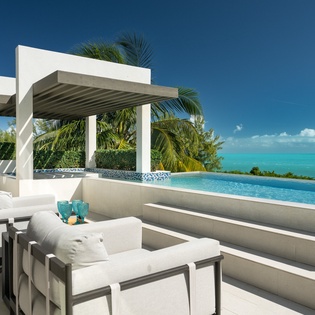 Your private infinity pool overlooks stunning turquoise waters, where comfort meets paradise in this luxurious outdoor sanctuary.