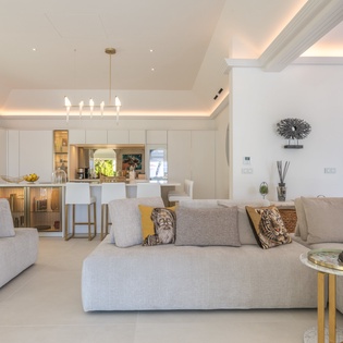 Sink into plush sofas in your elegant living space, where warm lighting and thoughtful design create the perfect atmosphere for relaxation.