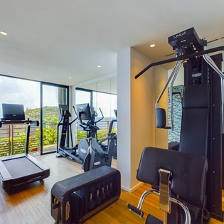 Work out while soaking in breathtaking ocean views through floor-to-ceiling windows in your private fitness sanctuary.
