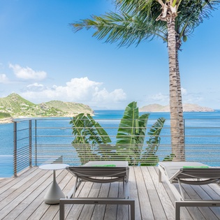 Unwind on your private deck where pristine waters meet tropical paradise, complete with loungers for endless ocean gazing.
