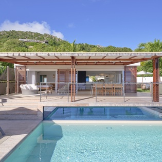 Dive into your private paradise with crystal-clear pool waters and seamless indoor-outdoor living under tropical skies.