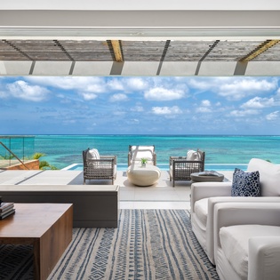 Unwind in your private oasis with panoramic ocean views, where plush seating and tropical breezes create the perfect retreat.
