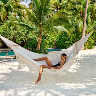 Drift away in your private hammock beneath swaying palms, with the sparkling pool just steps away for the perfect tropical escape.