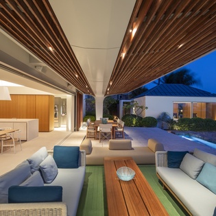 Unwind in your expansive living space where sleek design meets total relaxation, opening seamlessly to your private pool paradise.