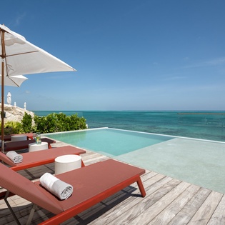 Relax on your private infinity pool deck with stunning ocean views and comfortable loungers.
