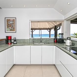 Cook in your fully equipped kitchen while gazing at stunning ocean views through the open-air pavilion. The space is bright, modern, and ready for your culinary adventures.