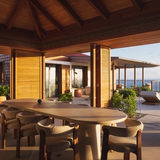 Your private dining terrace frames endless ocean views, where tropical breezes dance through palm fronds as you dine beneath beautifully crafted wooden beams.