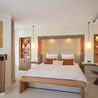 Luxurious bedroom featuring custom wood furnishings, modern lighting, and plush bedding for your perfect retreat.
