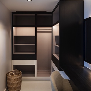 Your spacious walk-in closet offers abundant storage with built-in shelving and hanging space, perfect for organizing your wardrobe in style.