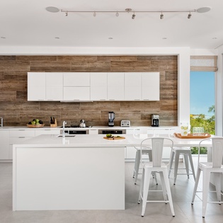 Your sleek modern kitchen awaits with white quartz counters and warm wood accents, perfect for cooking memorable meals.