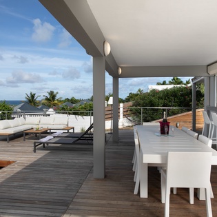 Your private rooftop terrace features a serene lounging area, spacious dining setup, and a refreshing plunge pool—all framed by stunning sea and tropical views.