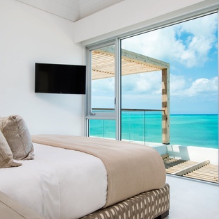 Wake up to turquoise waters stretching endlessly from your bed, with a private terrace just steps away for morning coffee overlooking paradise.