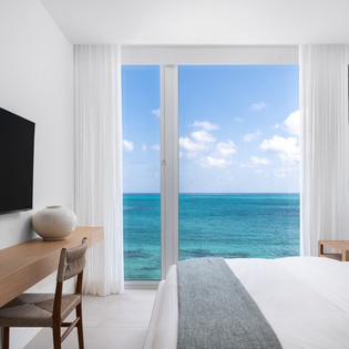 Wake up to stunning ocean views through your private windows, where turquoise waters stretch endlessly beyond your comfortable bedroom retreat.