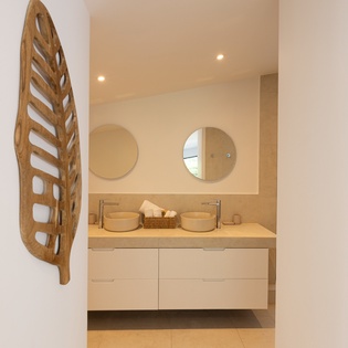 Step into your spa-like sanctuary featuring dual vessel sinks and warm natural tones for your ultimate relaxation.