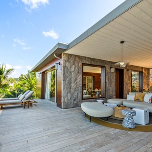 Stunning modern villa with covered terrace showcasing contemporary design and tropical surroundings.