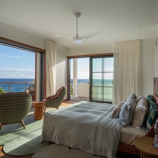 Wake up to breathtaking ocean views from your stylish bedroom, where floor-to-ceiling windows frame endless blue horizons.