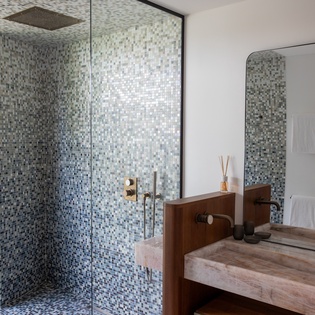 Step into your spa-like ensuite, where mosaic tiles and a rainfall shower create your perfect morning sanctuary.