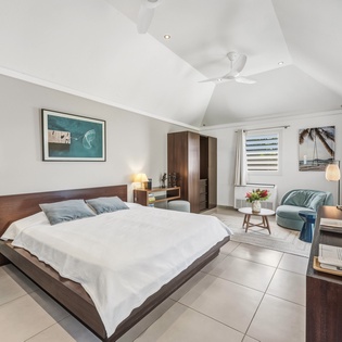Your serene bedroom retreat features a plush king bed, cozy seating nook, and modern amenities for ultimate comfort.