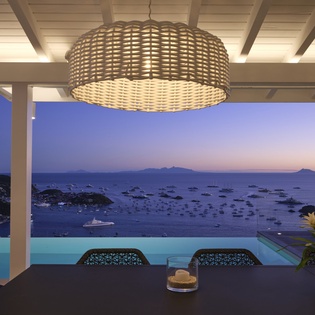 Dine under the stars at your private terrace, where panoramic sea views and an infinity pool create the perfect evening backdrop.