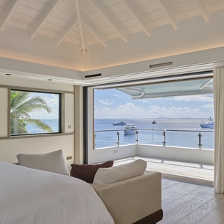 Wake up to stunning ocean views from your luxurious bedroom with floor-to-ceiling windows opening to endless blue horizons.