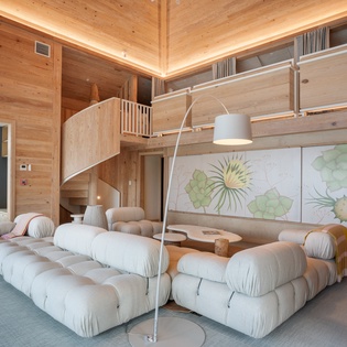 Unwind in your modern loft with plush seating and warm wood throughout, perfect for relaxing after your adventures.