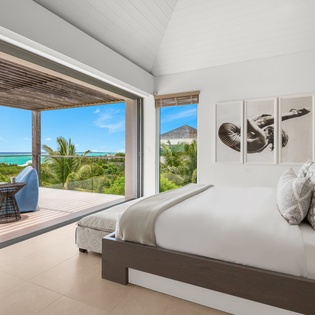 Wake up to breathtaking turquoise waters and swaying palms from your luxurious bedroom, where floor-to-ceiling windows frame paradise perfectly.
