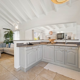 Your spacious kitchen features granite counters, modern appliances, and opens to the cozy living area for effortless entertaining.