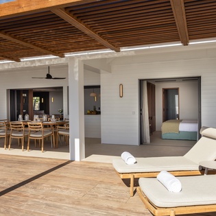 Unwind on your private terrace with plush loungers and towels, overlooking your open-plan dining space and bedroom suite.