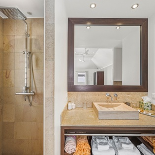 Pamper yourself in this spa-inspired bathroom with rainfall shower and elegant stone vanity.